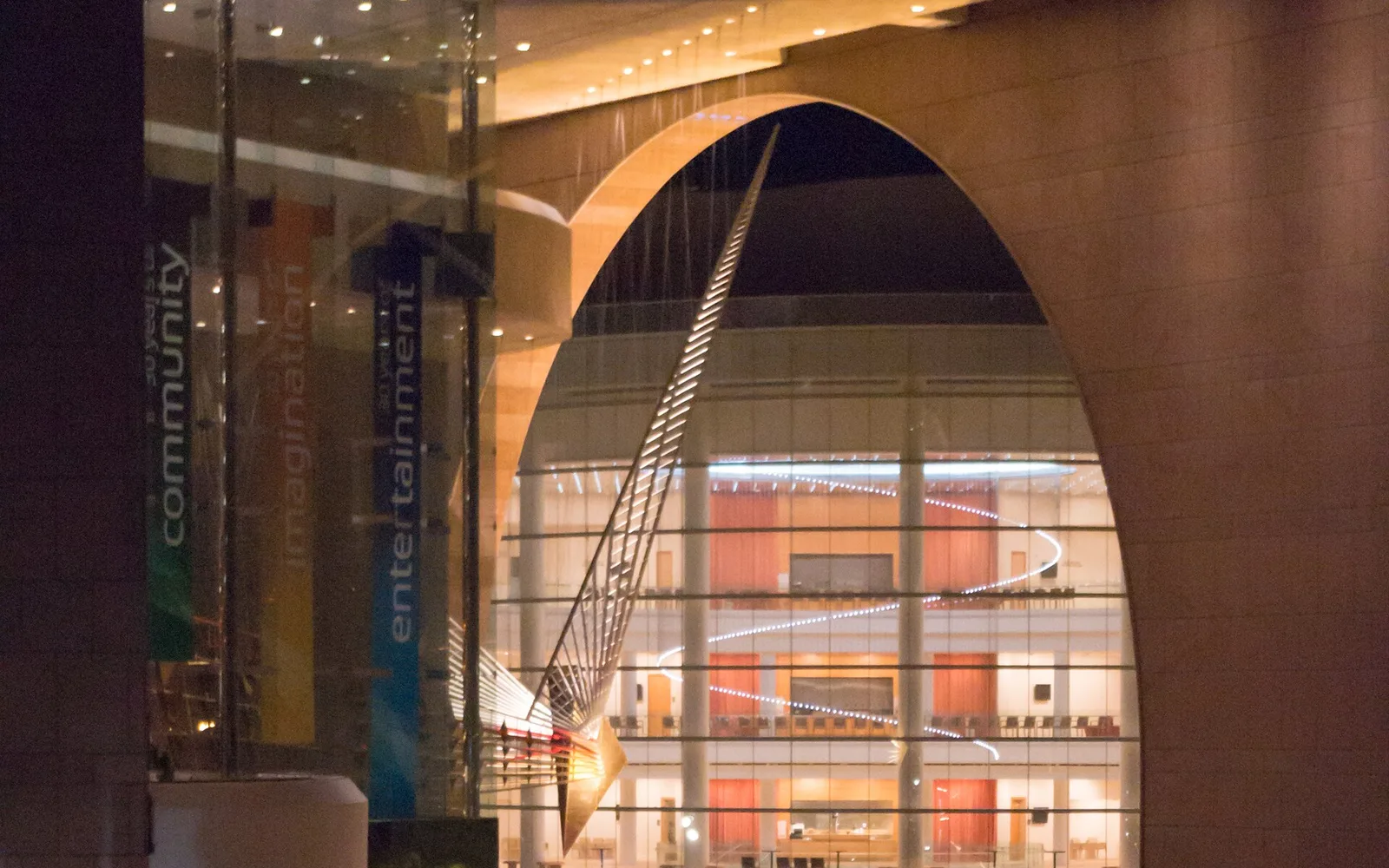 Illuminated glass facade and arch at Segerstrom Center for the Arts in Costa Mesa.